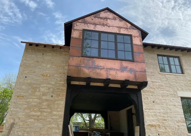 Copper metal panel facade on a stone building for Roof Repair in Elk Ridge